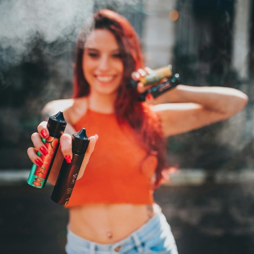 woman holding e-liquid bottles